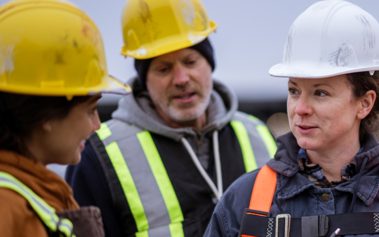 Construction workers discussing safety procedures on site